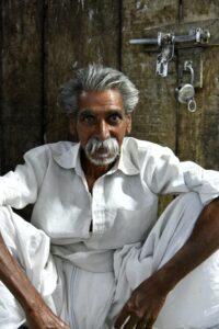 a hindu man wearing a white shirt and a white dhoti